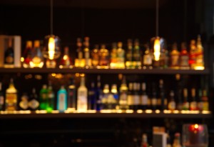 blur alcohol drink bottle at pub in dark night background